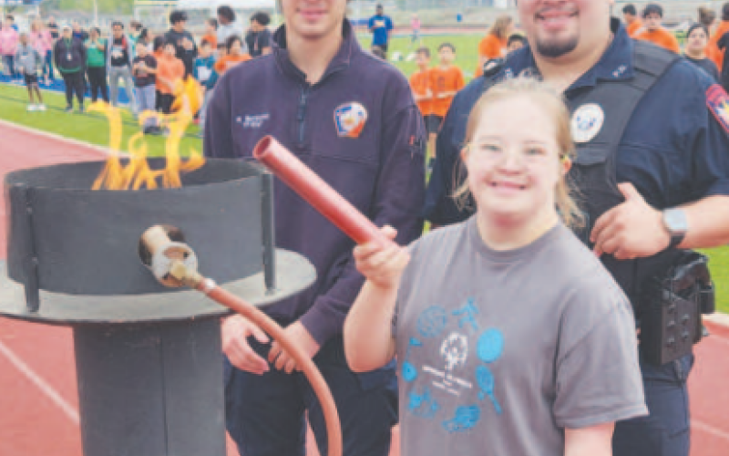The lighting of the torch during the 2024 DeWitt Lavaca Special Olympics opening ceremony on March 22. Pictured in the front center is student Macy Svec. Pictured in the back row from left to right are Wesley Bordovsky with the Yoakum Fire Department and Mason Galzan with the Yoakum Police Department. Staff photo.