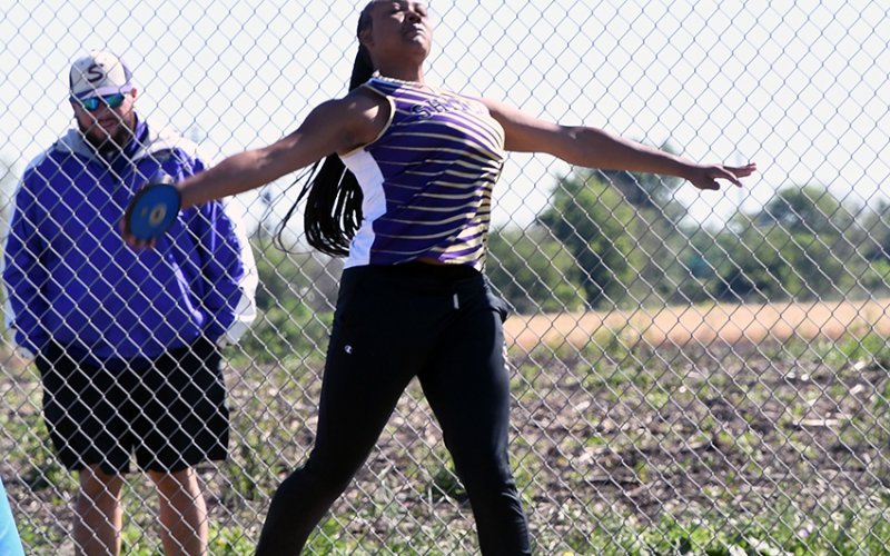 Nevaeh Jones flings the discus Thursday morning in Thrall. She placed second to advance to the regional meet with a throw of 115 feet, 3 inches. Photo by Mark Lube.