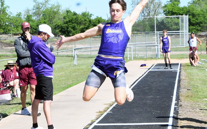 Jordan Harrison flys through the air during the long jump. He won the event with 20 feet, 3.5 inches. Trace Bishop was second. Photo by Mark Lube.