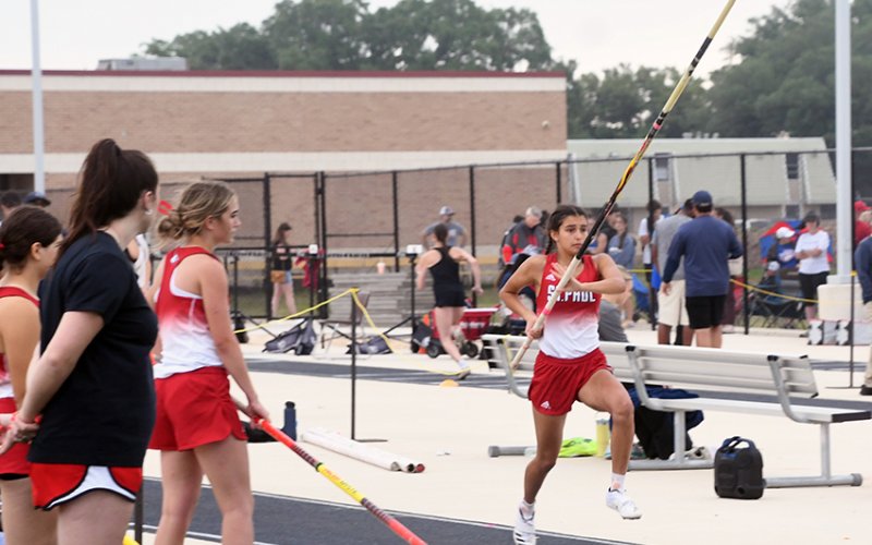Nora Koch takes off down the runway during the pole vault.  She got first place with a vault of 8 feet. Photo by Mark Lube.