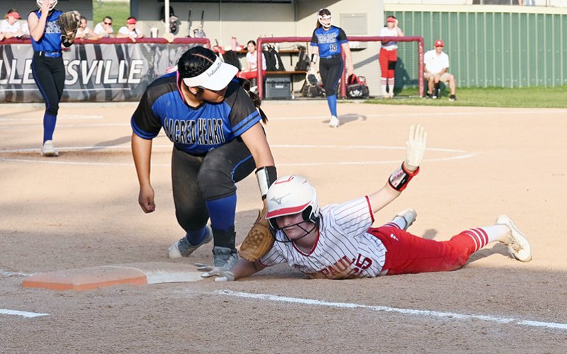 Lady Cardinal Sam Moeller calls for time after a pickoff attempt Thursday at Sacred Heart. The Indianettes completed the sweep but St. Paul kept the score a lot closer as they came up just short 14-13. Photo by Chuck Grafe/Hallettsville Tribune-Herald.