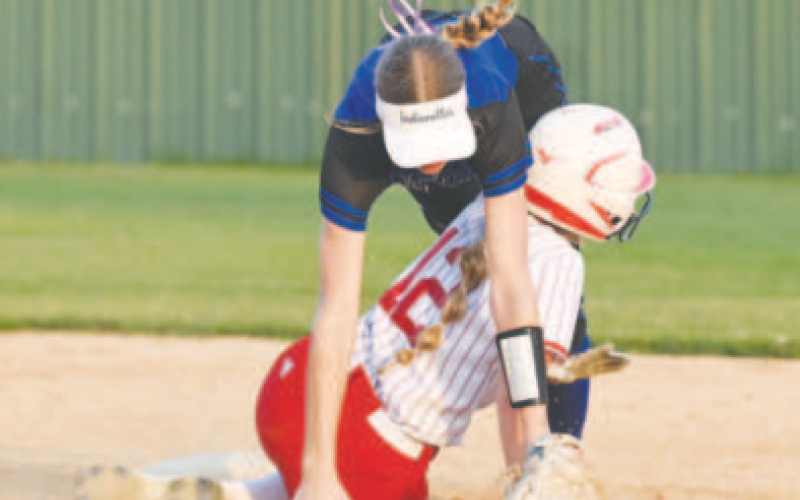 Indianette shortstop Rylan Dworsky and St. Paul’s Sloane Kocian tangle up at second base. Chuck Grafe/Tribune-Herald