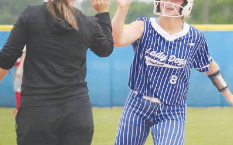 Yoakum High School Lady Bulldog Olivia Fojt gets a high-five from Coach Monica Chovanec after hitting a homerun. Contributed photo.