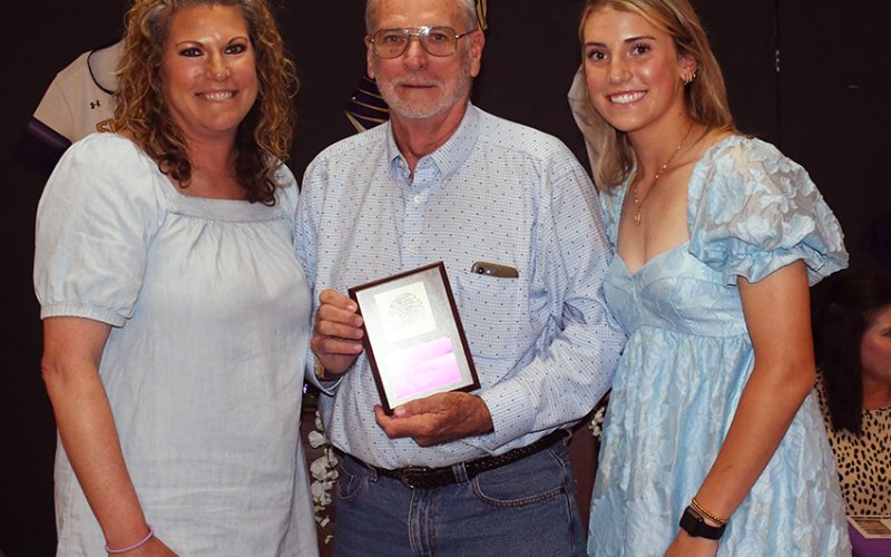 Shiner Comanche Fan of the Year, Howard Stridde (middle). Also shown is Cari Lynn Siegel (left) and Addy Siegel (right). Photo by Mark Lube.