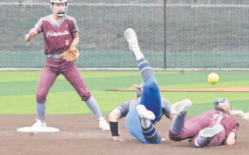 Lady Brahma second baseman Madison Mikes takes a tumble after being run over by Natalia’s Cindy Jimenez, who was called out for interference. Chuck Grafe/Tribune-Herald