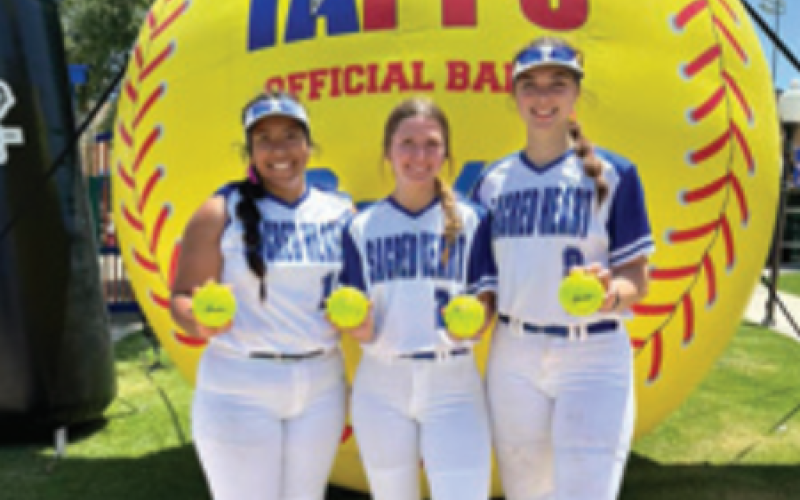 From left, Aracely Guzman, Haley Noska and Ava Lackey with the balls they hit for home runs in the semifinal game. Lisa Noska for the Tribune-Herald