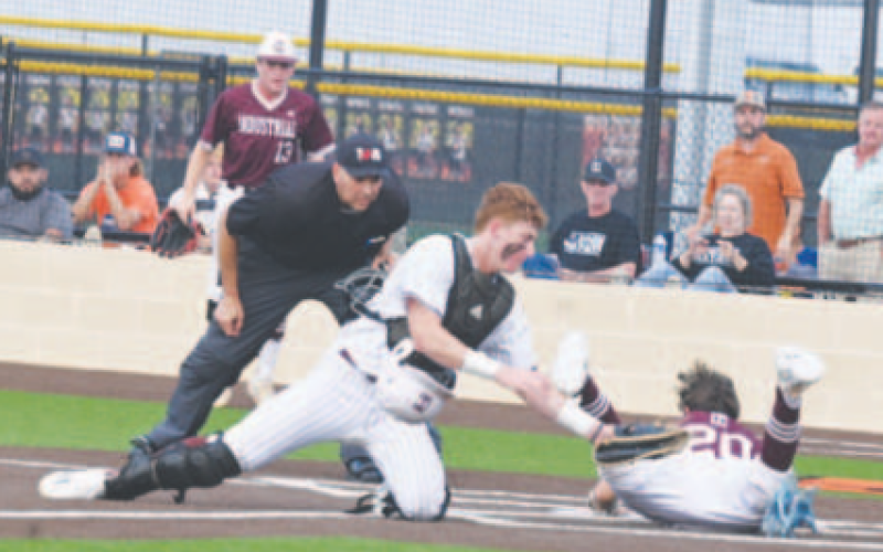 Carter Blaha could not get the tag down on time on Industrial’s Sam Kurtz. Chuck Grafe/Tribune-Herald