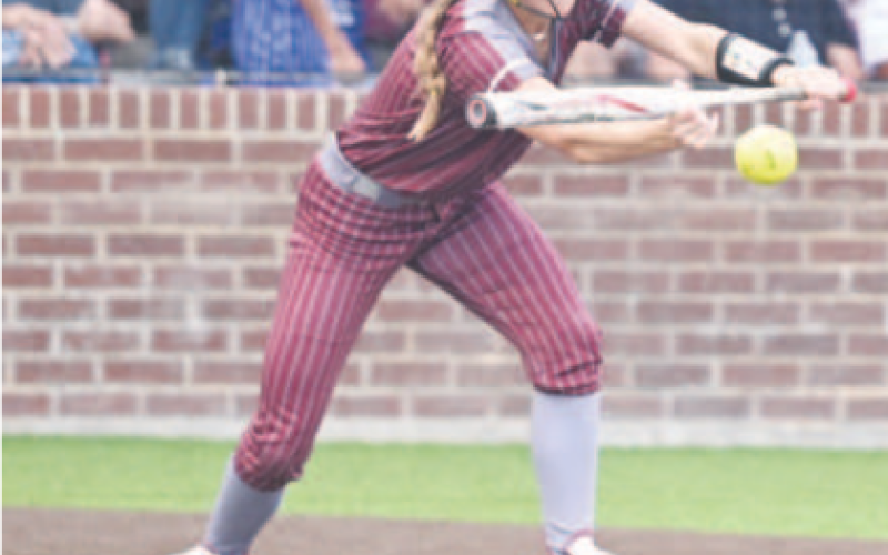 Macey Pustka puts down a sacrifice bunt in the fifth inning of Game 1. Chuck Grafe/Tribune-Herald