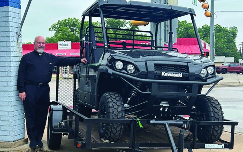 Father Bryan Heyer is pictured with a 2024 Kawasaki Mule Pro FXT, which will be given away at this weekend’s picnic. Included is a 12 ft. utility trailer with ramp gate, generously donated by Boehm Tractor Sales. If you would like to purchase a ticket, please call the church office or visit the church’s website, www.sscmshiner.org.