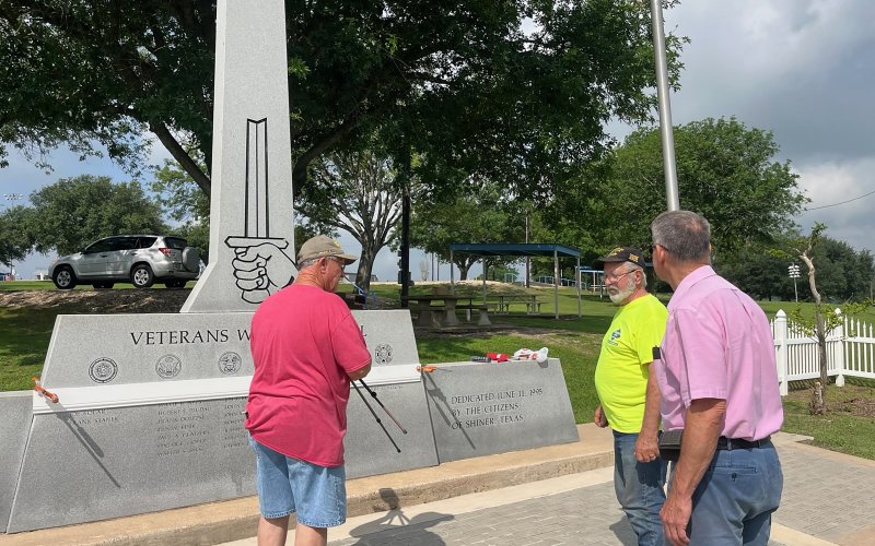 Members of American Legion Post 201 and VFW Post 6209 prepare the memorial for installation of the bronze insignias. Pictured are, left to right, Jimmy Strait, Reggie Guertin and Ronnie Leck.