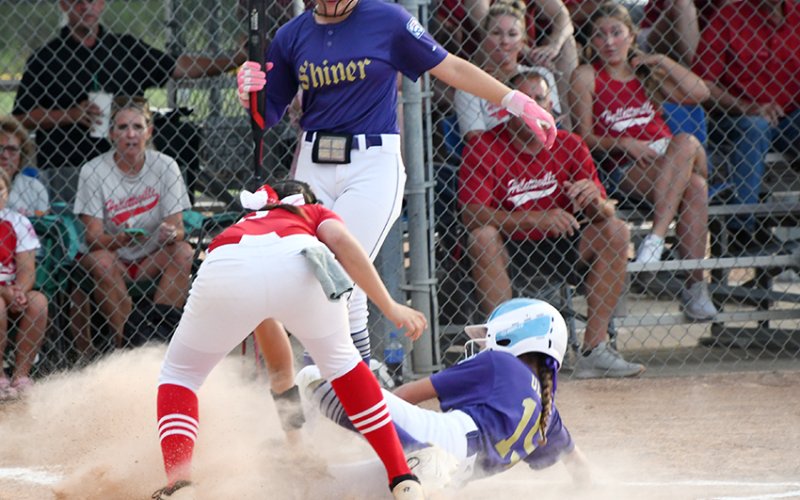 Shiner Major Softball’s Addison Ulcak slides into home plate in the first inning against Hallettsville Red on June 18. She scored the lone run for Shiner.   Photo by Mark Lube.