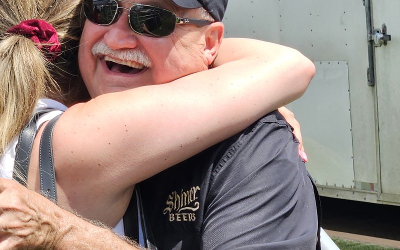 Jimmy Mauric shares a hug at Summerfest.