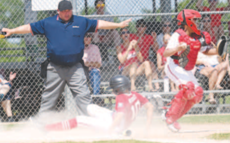 Ty Rother scores after a base hit by Myles Kalmus Saturday. Chuck Grafe/ Tribune-Herald