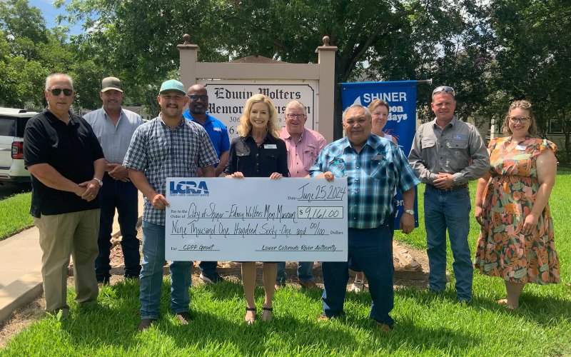 LCRA representatives present a $9,161 grant to the City of Shiner’s Edwin Wolters Memorial Museum to install two mini-split HVAC units and update the building’s wiring.