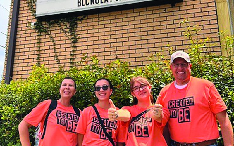 Teena Davis, Emma Davis, Bee Baker, and Pastor Chris Heinold, left to right, pose outside Bethlehem Lutheran Church where they performed volunteer work.