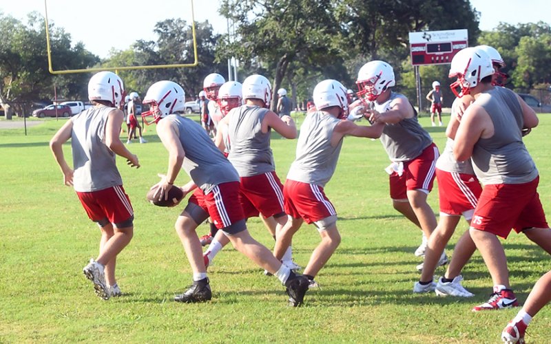 St. Paul offense runs a play on the second day of practice as they learn the system of new head coach Barry Wolf. Photo by Mark Lube.