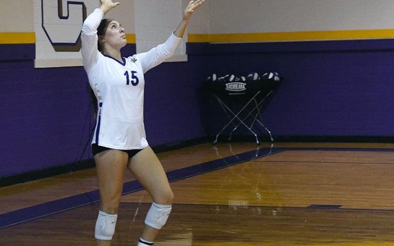 Brinley Ramirez tosses the ball up for a serve. Photo by Mark Lube.