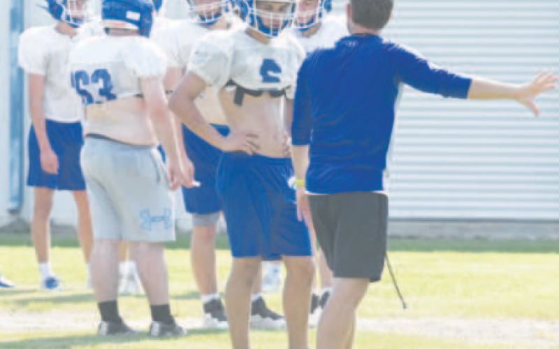 Indian assistant coach Randy Kaiser instructs Kellen Mechura at Monday’s practice. Chuck Grafe/Tribune-Herald