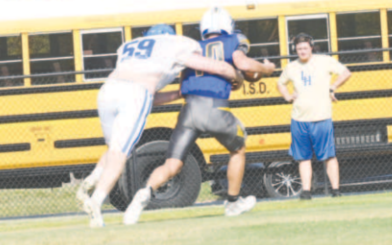 Brody Etzler records a sack in Thursday’s scrimmage with Louise. Chuck Grafe/Tribune-Herald