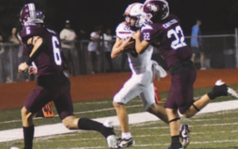 Jesse Cavazos (22) makes the tackle on Apache quarterback Tyler Hoffman. Chuck Grafe/Tribune-Herald