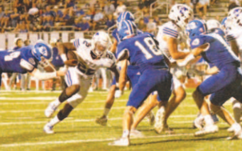 Josh Terry, left, and Clayton Haas (18) close in on Flyers quarterback Aiden Aragon. Chuck Grafe/Tribune-Herald
