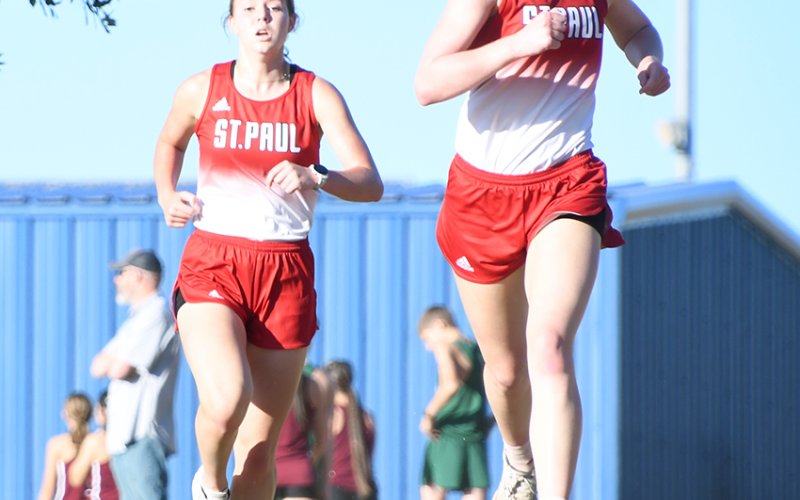 Kristin Cerny (left) and Skylar Mozisek (right) got the first two places of the varsity girls 1A-2A race to lead St. Paul to the team title. Photo by Mark Lube.