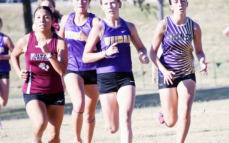 Megan Burns (far right) runs among athletes from Weimar and Flatonia at the 28-2A district cross country meet Monday at Green-Dickson Park. Burns placed fifth overall and qualified for the regional meet. Photo by Mark Lube.
