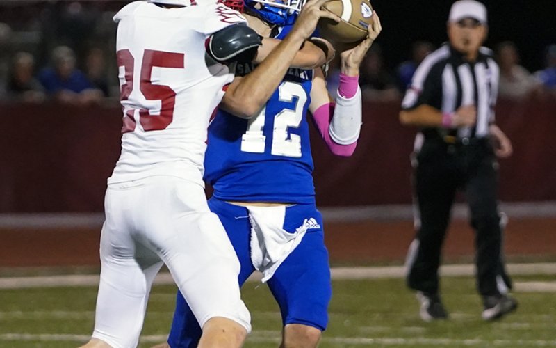 St. Paul safety Carter Chilek makes life uncomfortable for Indian quarterback Andrew Steffek on this play Friday in Hallettsville in the 28-6 win for Sacred Heart. Photo courtesy of Photos by Lori Raabe.