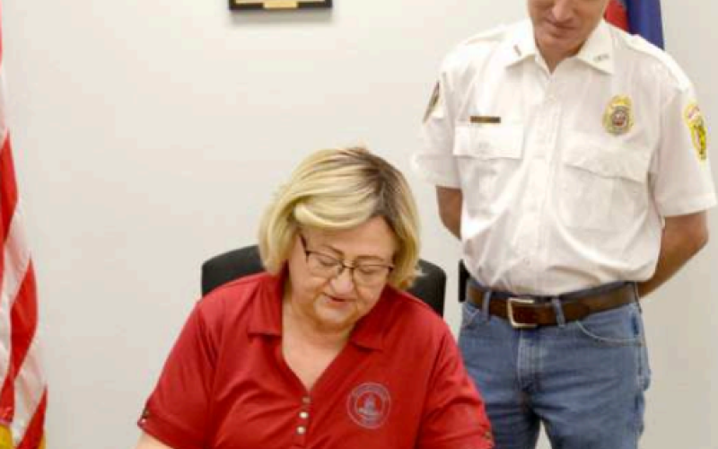 Fire Prevention Week is Oct. 6 through 12 and this year’s theme is “Smoke alarms: Make them work for you”. The week focuses on educating people about having workable smoke alarms in the home. Seated and signing the proclamation is Hallettsville mayor Alice Summers with Hallettsville Volunteer Fire Department chief Stephen Grahmann present for the signing. Photo by Jimmy Appelt