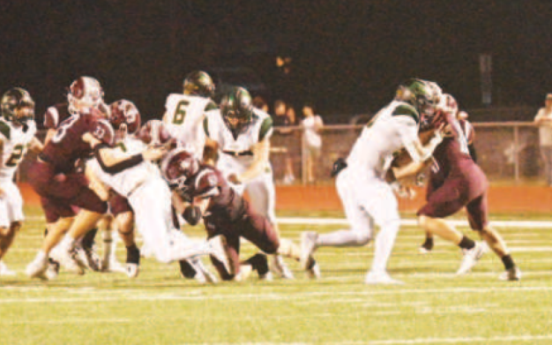 Nathan Henke (33) and Aiden Drozd (52) make a tackle in the third quarter.