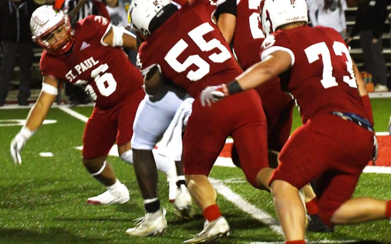 The St. Paul defense makes a team tackle against Fort Worth Temple Christian last Friday in Temple. Photo by Mark Lube.