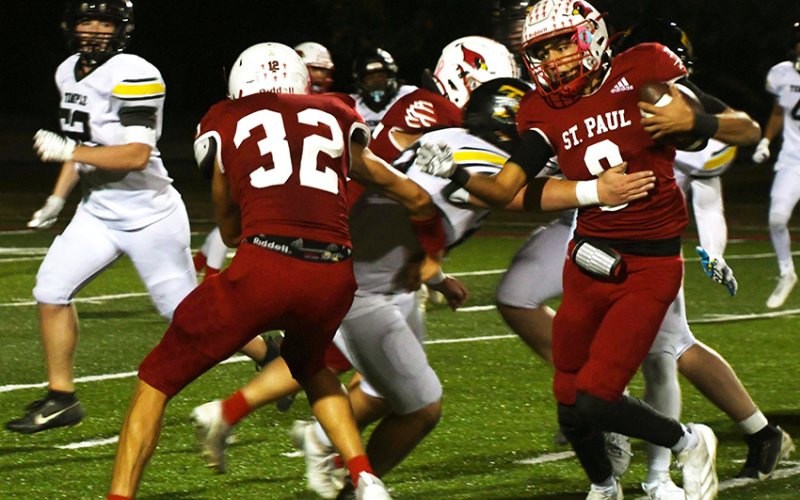 Zeke Rodriguez runs with the football while Gabe Darilek (32) blocks some FWTC defenders during the Cardinals’ 48-7 win in the TAPPS 2A area round at Temple Central Texas Christian School. Photo by Mark Lube.