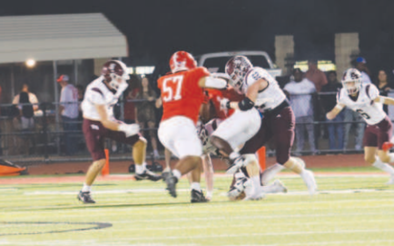 Aiden Drozd (62) wraps up Columbus’ Bryan Salazar. Chuck Grafe/Tribune-Herald