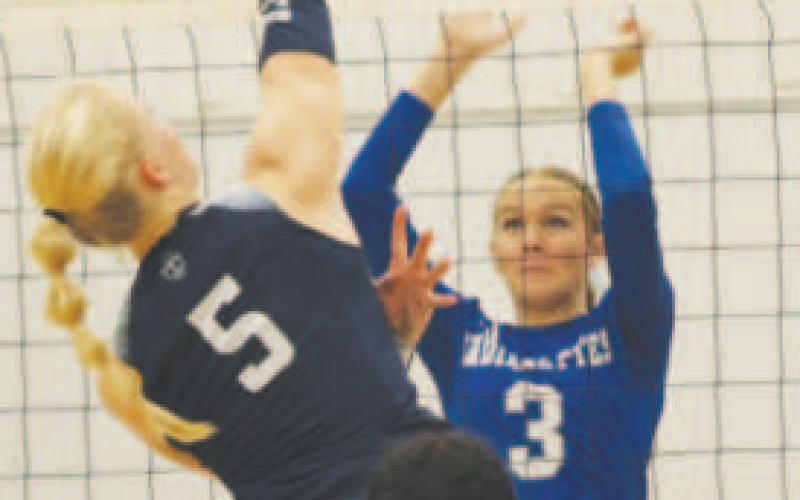 Layne Besetzny (3) goes up for a block. Chuck Grafe/ Tribune-Herald