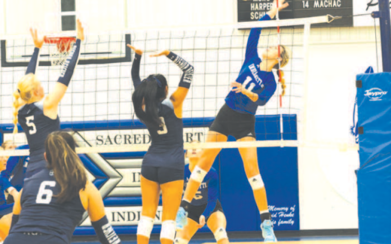 Senior Middle Mallory Mueller (11) served 5 aces to go along with 6 kills in the victory over Bishop Reicher here Saturday.. Chuck Grafe/Tribune-Herald