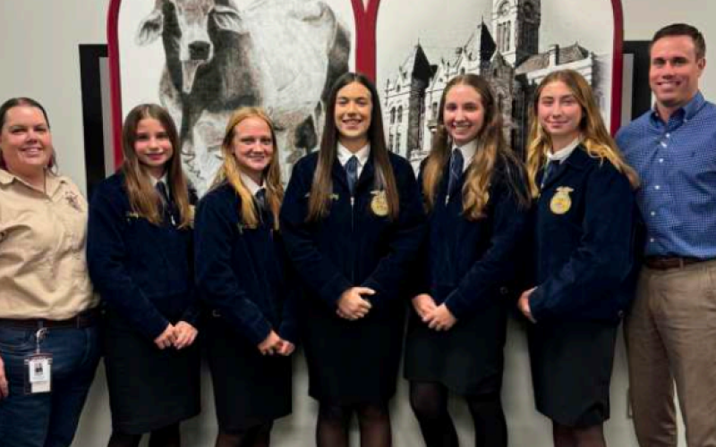 The Hallettsville FFA Ag Issues Team presented an informative debate on the advantages and disadvantages of both conventional and autonomous tractors. From left are Hallettsville Ag-Science instructor Mallory Haas, Ag Issues team members Kaisly Bludau, Alyssa Smith, Aubrey Freytag, Kenley Kalmus, Taylor Yeatts, and HHS principal Mason Briscoe. Photo by Trina Patek
