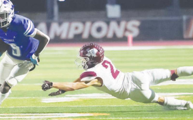 Kennan Dilworth runs past a Trojan defender. Photo courtesy of Raymond Rosas.