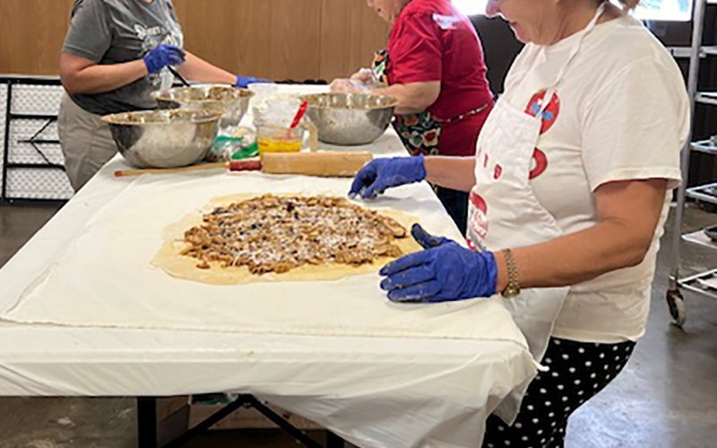 Lisa Stock, Mary Ann Stock and Monica Peters, left to right, work at assembling strudels.