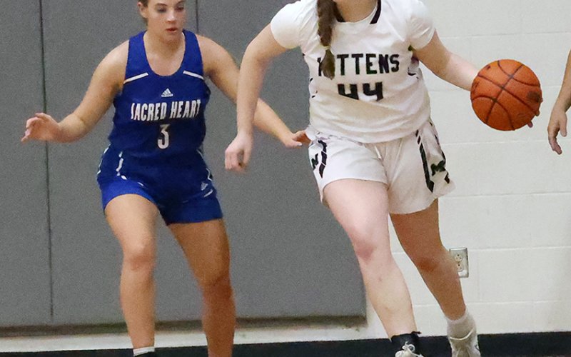 Audrey Swinford moves the ball away from Indianette Brianna Clark in the Kittens game against Sacred Heart. Photo courtesy of Chuck Grafe/Hallettsville Tribune-Herald.