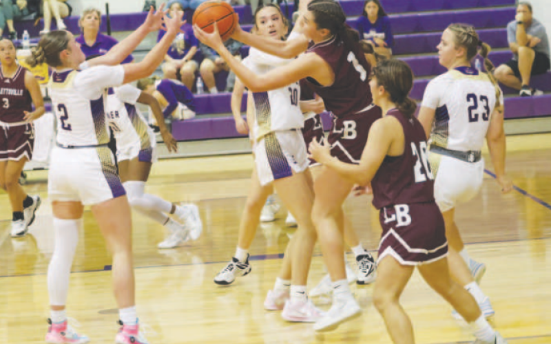 Christine Felcman (1) grabs a rebound from Shiner’s Callie Sevcik (2). Chuck Grafe/Tribune-Herald