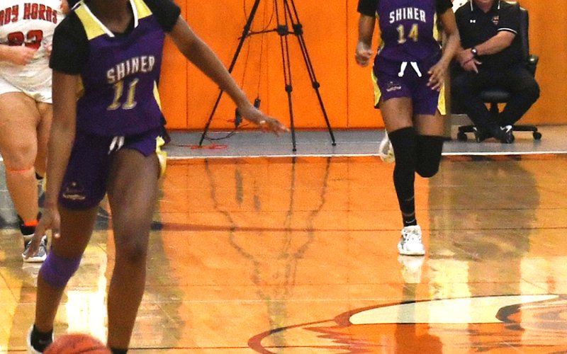 Jaliyah Barnett (left) makes her way up court after gaining possession while teammate JaMya Wright trails the play Feb. 4 in Schulenburg. Photo by Mark Lube.