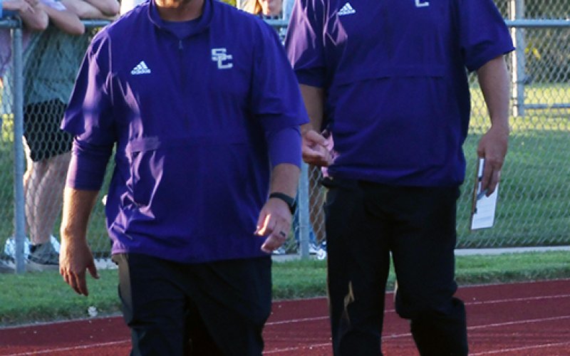 Shiner offensive coordinator, quarterbacks coach and head boys track coach Randy Palmer (right, shown here with head coach Daniel Boedeker prior to the Hallettsville football game in August)  has returned home to Pleasanton to serve as head football coach. Photo by Mark Lube.