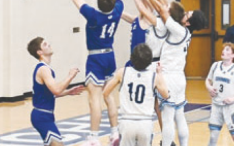 Kolby Haas (14) grabs a rebound. Melissa Kutac for the Tribune-Herald