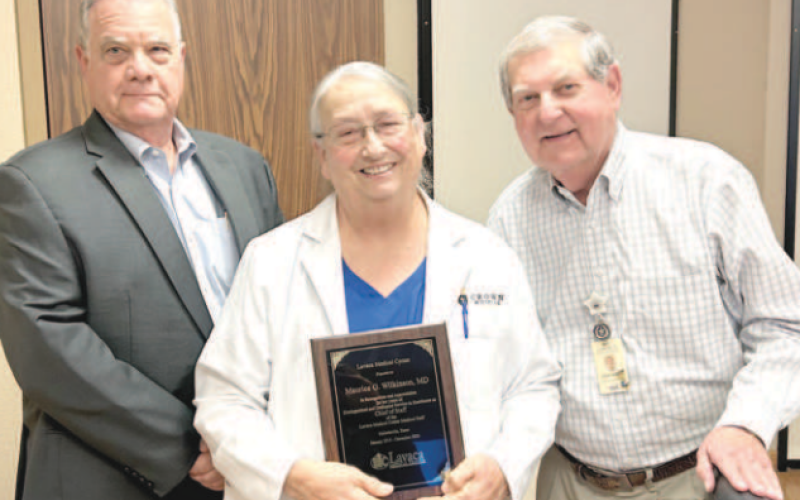 At Monday’s Lavaca Hospital District Board of Directors meeting, Lavaca Medical Center physician Dr. Maurice Wilkinson was honored for her many years of dedicated service to the hospital. From left are LHD president James Fenner, Wilkinson, and LMC administrator Steve Bowen. Photo by Jimmy Appelt