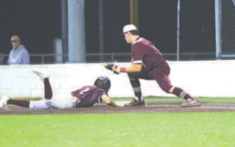 Preston Wagner scores on a wild pitch against Ganado. Chuck Grafe/TribuneHerald