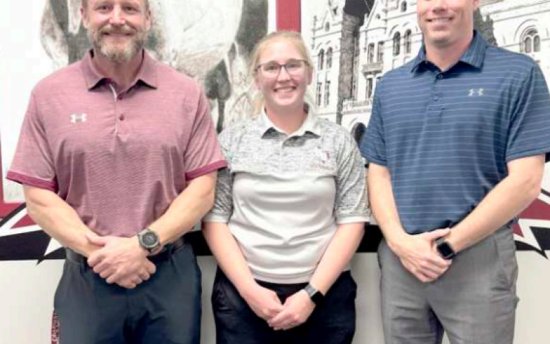 The month of March is National Athletic Training month and Hallettsville ISD athletic trainer, Shannon Flores, was recognized at the Monday, March 10 HISD Board of Trustees meeting. From left are HISD athletic director/head football coach Levi Montgomery, Flores, and HHS principal Mason Briscoe. Photo by Trina Patek