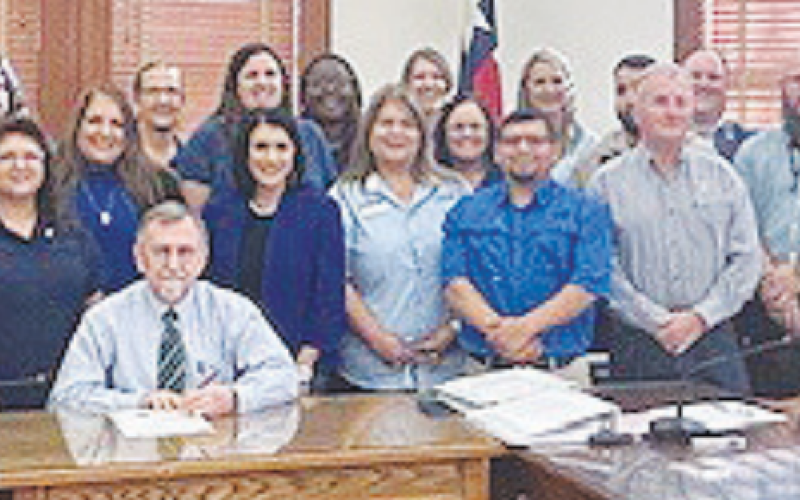 Members of the DeWitt County Child Welfare Board, Norma's House and BELONG pose with commissioners as they make a proclamation establishing April as National Child Abuse Prevention Month.