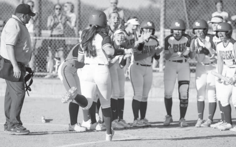 Ella Demel is greeted at home plate after hitting her sixth home run of the season against St. Paul Thursday. Mark Lube/Shiner Gazette