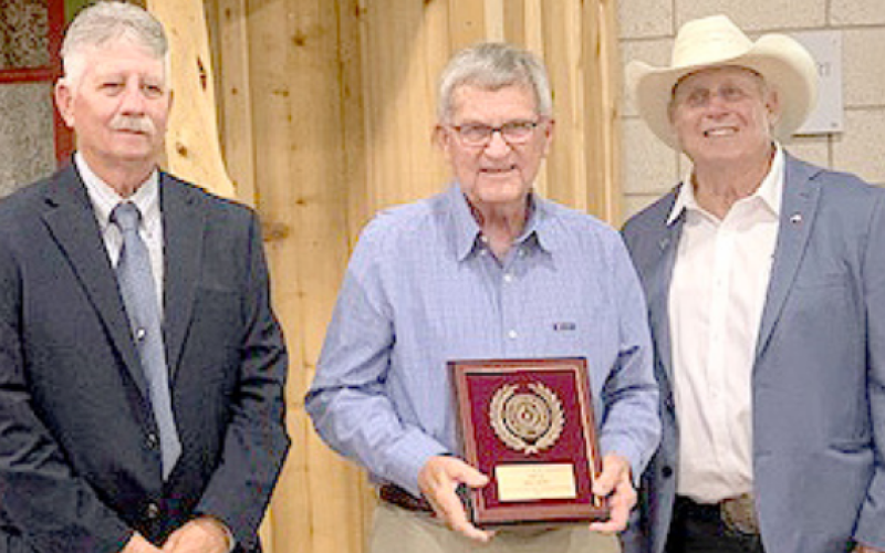 Hallettsville Tribune-Herald staff writer Jimmy Appelt was presented the first place Friends of Conservation award at the Area III Conservation Awards Banquet held Tuesday, May 6 at the Anne Thomas Friar Homemaking Building in Cuero. From left are Leroy Wolff, vice-president of the Association of Texas Soil and Water Conservation Districts, Appelt, and Jose Dodier, a member of the Texas State Soil and Water Conservation Board. Photo by Dennis Evins