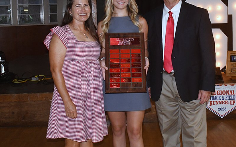 James Muelker Memorial Scholarship winner Dallyn Pesek (center). Also shown are Nicco Brown (left) and Barry Wolf (right, athletic director). Photo by Mark Lube.